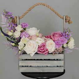Стильный дизайнерский букет в ящике из роз, гвоздик и лизиантусов в сиреневых тонах